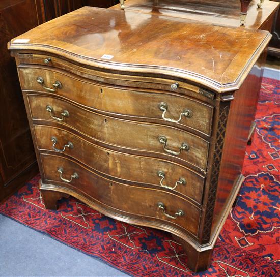 A serpentine chest of drawers with brushing slide W.79cm